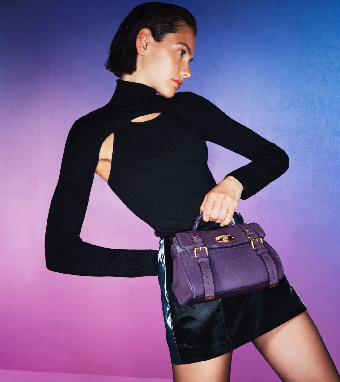 model holding mulberry mini alexa bag in purple